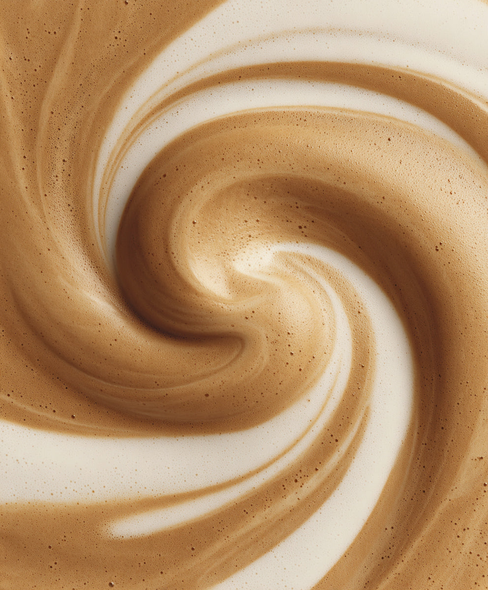 Coffee and cream in smooth whirl macro texture