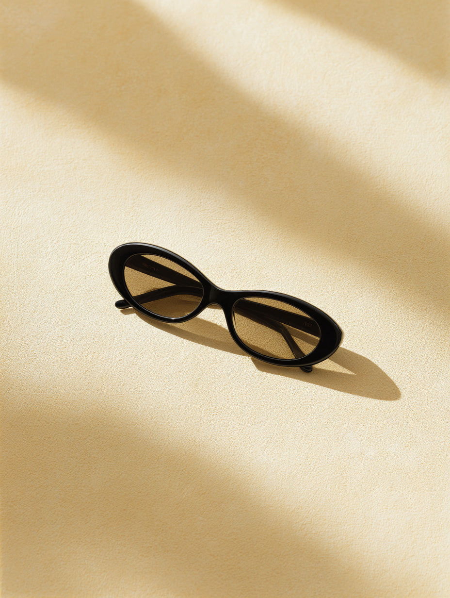 black sunglasses flatlay on beige background